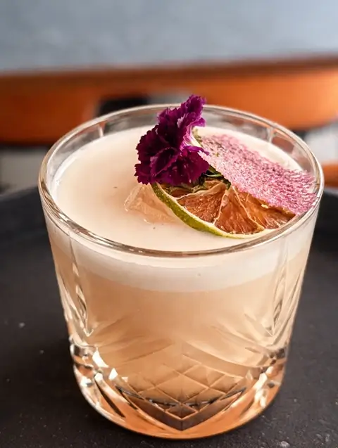 Basil True Love cocktail on an orange background