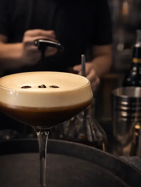 Espresso Martini cocktail on an orange background